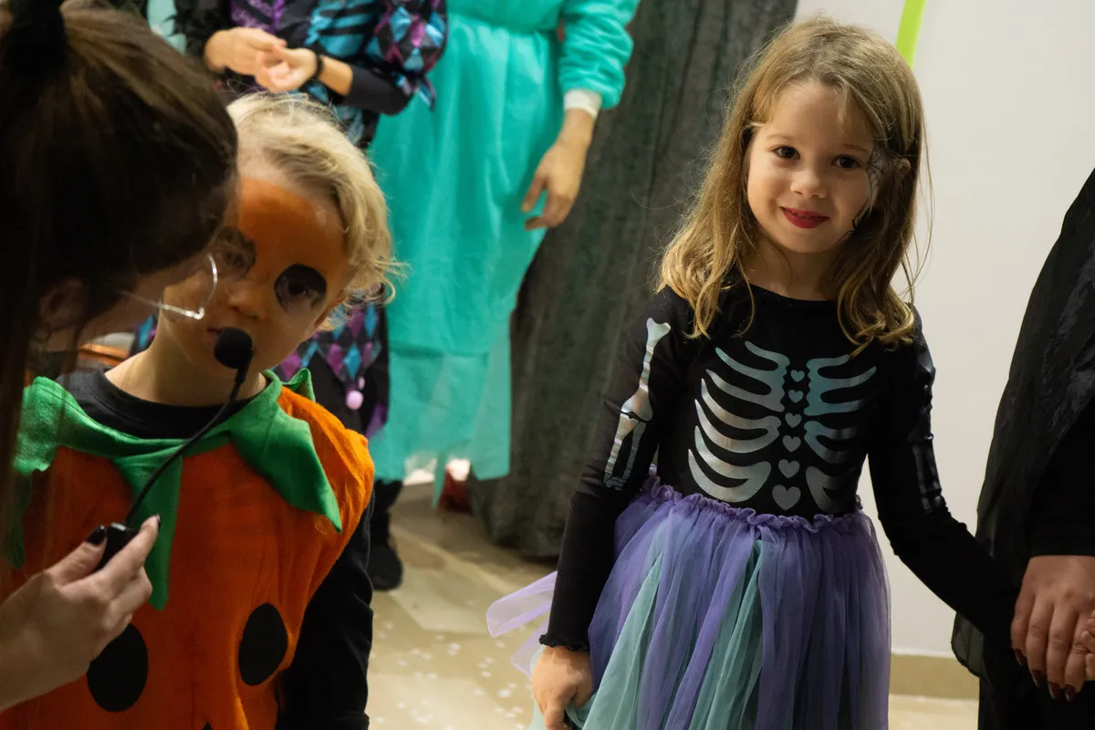 Bambini in costume da zucca e da scheletro alla festa di Halloween